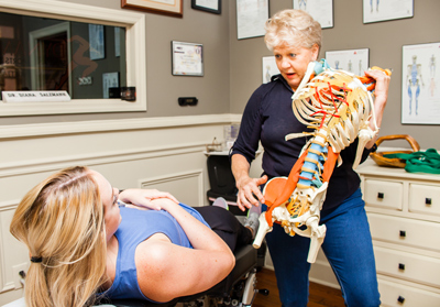 Chiropractor describes a procedure to a patient